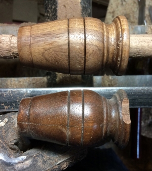 The original leg piece at the bottom of the frame, with the final walnut piece above it, still on the lathe. The final piece includes a 5/8 inch tenon on the right, which is how the piece will attach to the existing leg.